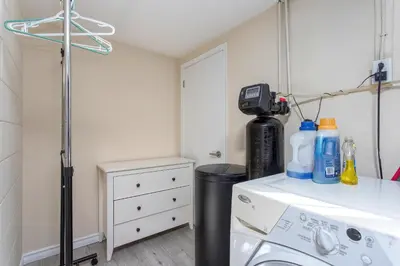 a laundry room with a sink and a washing machine at Bright & Modern 1 bedroom unit! in Guelph