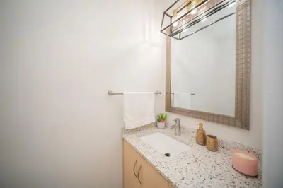 a bathroom with a sink and a mirror at Peaceful Heartland KingBed Workstation BackyardFun in Mississauga