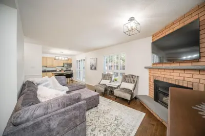 a living room with a couch and a fireplace at Peaceful Heartland KingBed Workstation BackyardFun in Mississauga