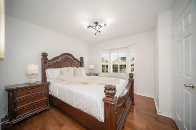 a bedroom with a bed and a dresser and a window at Peaceful Heartland KingBed Workstation BackyardFun in Mississauga