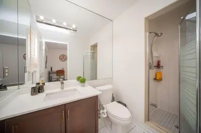 a bathroom with a sink and a toilet and a shower at Peaceful Heartland KingBed Workstation BackyardFun in Mississauga