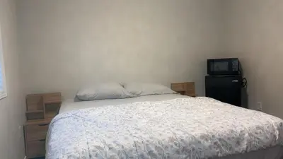 a bedroom with a bed and a microwave at Near Toronto Pearson Airport Queen Room in Brampton