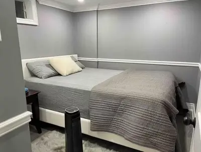 a small bedroom with a bed and a table at Full Privacy Entire basement,kitchen,1parking in Oshawa