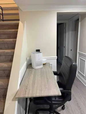 a table and a chair in a room with stairs at Full Privacy Entire basement,kitchen,1parking in Oshawa