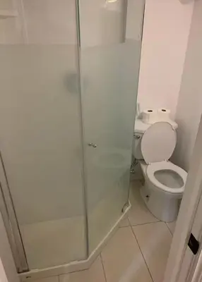 a bathroom with a toilet and a glass shower at Full Privacy Entire basement,kitchen,1parking in Oshawa