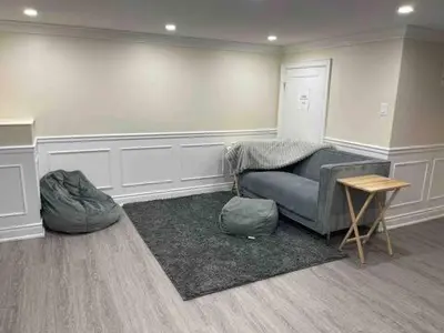 a living room with a couch and a table at Full Privacy Entire basement,kitchen,1parking in Oshawa