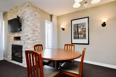a dining room with a table and a fireplace at Relaxing 2BR Retreat at Carriage Hills in Edgar