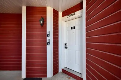 a red house with a white door and a sign that reads moth at Relaxing 2BR Retreat at Carriage Hills in Edgar