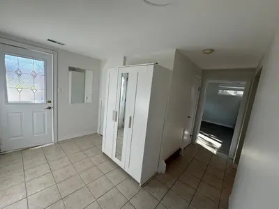 an empty hallway with a door and a window at 1 bedroom cozy apartment in Kitchener