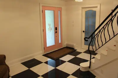a hallway with a door and a checkered floor at Boutique Accommodation in PEC - Suite 4 in Belleville
