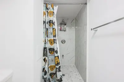 a shower curtain with faces on it in a bathroom at Exquisite 2-Bdrm Basement Suite with FREE Parking in Bradford