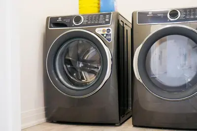 two washing machines sitting next to each other at Spacious 3 Bdrm Retreat, Muskoka Room & Fireplace in Bracebridge
