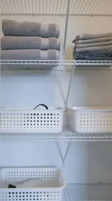 a shelf with baskets and towels in a closet at Spacious 3 Bdrm Retreat, Muskoka Room & Fireplace in Bracebridge