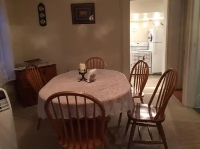 a dining room table with chairs and a candle on it at Charming Farmhouse in the City, Near Wine Country in Belleville