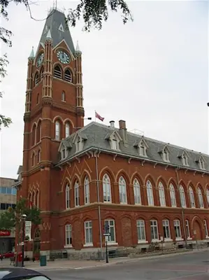 a large red brick building with a clock tower at Charming Farmhouse in the City, Near Wine Country in Belleville