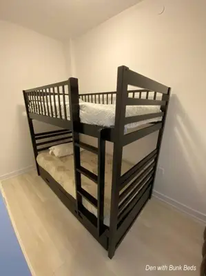 a black bunk bed in the corner of a room at Beautiful Condo, 2 Bedrooms and a Den in Friday Harbour Resort! in Innisfil