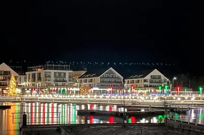 a city lit up at night with christmas lights at Beautiful Condo, 2 Bedrooms and a Den in Friday Harbour Resort! in Innisfil