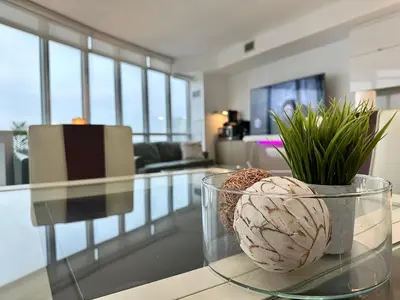 a glass table with a vase with plants on it at Cityview in the Sky 2Bdrms 2Baths 5realbeds in Toronto