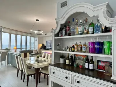 a kitchen and dining room with a table with bottles of wine at Cityview in the Sky 2Bdrms 2Baths 5realbeds in Toronto