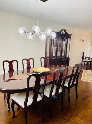 a dining room with a wooden table and chairs at Three bedroom house in Mississauga