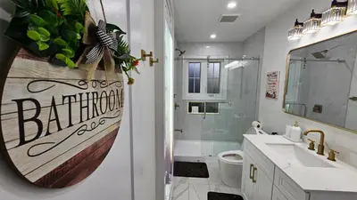 a bathroom with a sink and a toilet and a mirror at Luxury Family House 3 beds, 1 bath, 5 guest in Toronto