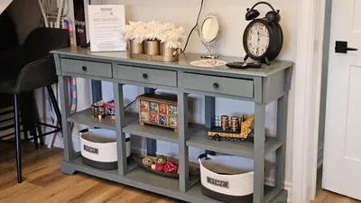 a gray console table with plates and a clock on it at Luxury Family House 3 beds, 1 bath, 5 guest in Toronto