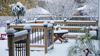 a wooden bench covered in snow next to a fence at Luxury Family House 3 beds, 1 bath, 5 guest in Toronto