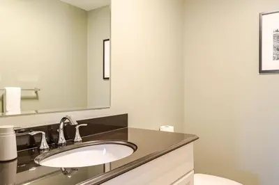 a bathroom with a sink and a mirror at Forest Hideaway in Hespeler
