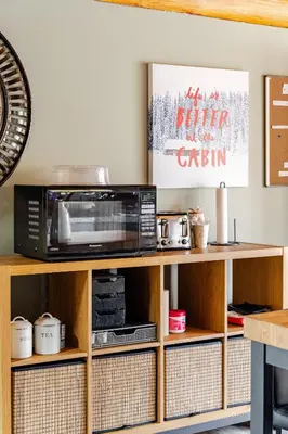 a microwave oven sitting on top of a wooden shelf at Forest Hideaway in Hespeler