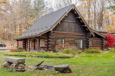 a log cabin with a gambrel roof at Forest Hideaway in Hespeler
