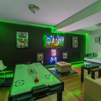 a living room with a ping pong table and neon lights at Retro Arcade & Gaming Home by Pako Stays in Brampton