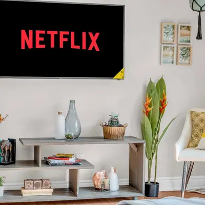a living room with a netflix sign on the wall at Retro Arcade & Gaming Home by Pako Stays in Brampton