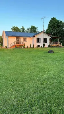 a house in a field with a large yard at Westlake waterfront, hot tub, dock,4 mins to beach in West Lake