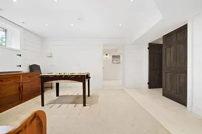 a living room with a desk and a television at Westlake waterfront, hot tub, dock,4 mins to beach in West Lake