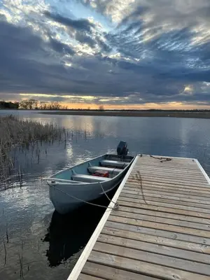 a boat tied to a dock on a lake at Westlake waterfront, hot tub, dock,4 mins to beach in West Lake