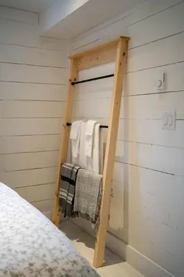a room with a ladder next to a bed at Westlake waterfront, hot tub, dock,4 mins to beach in West Lake