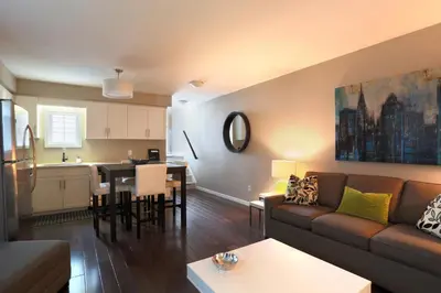 a living room and kitchen with a couch and a table at Boardwalk Homes - Executive Townhomes in Kitchener