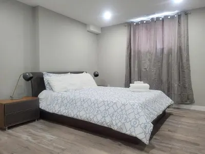 a bedroom with a bed and a window at Boardwalk Homes - Executive Townhomes in Kitchener