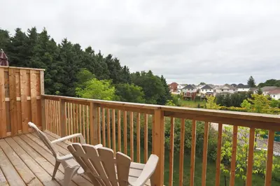 two chairs sitting on the deck of a house at Boardwalk Homes - Executive Townhomes in Kitchener