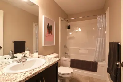 a bathroom with a sink and a toilet and a shower at Boardwalk Homes - Executive Townhomes in Kitchener