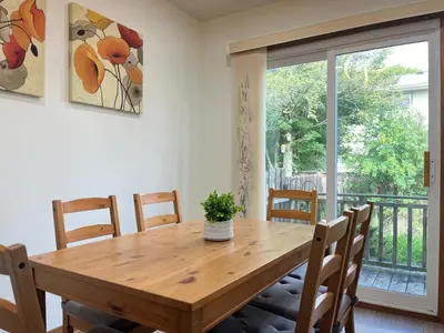 a dining room with a wooden table and chairs at Entire Cozy House in Thorold in Thorold