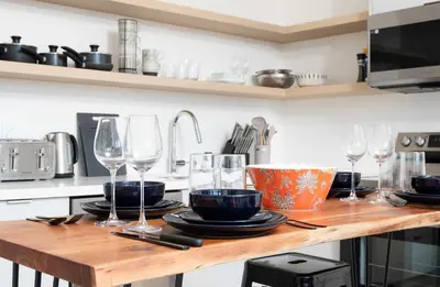 a kitchen with a wooden counter with wine glasses on it at Large Victorian Sleeps 6 by UofT in Toronto
