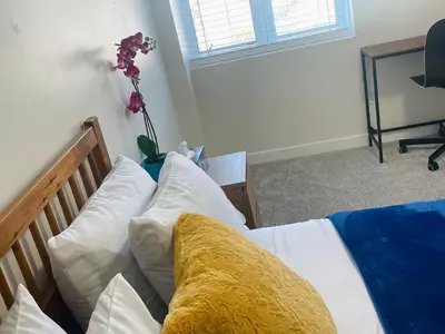 a bedroom with a bed with white pillows at New Cosy bright and Spacious Apartment in East Gwillimbury