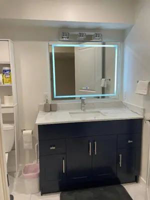 a bathroom with a sink and a mirror at New Cosy bright and Spacious Apartment in East Gwillimbury