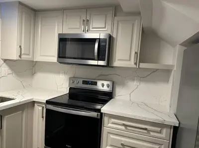 a kitchen with white cabinets and a microwave at Cozy Home away in Ajax 2 BR 1 bath 4 guests in Ajax