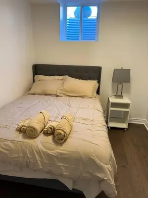 a bedroom with a bed with two towels on it at Cozy Home away in Ajax 2 BR 1 bath 4 guests in Ajax