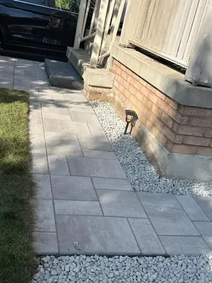 a bird sitting in the gravel next to a house at Cozy Home away in Ajax 2 BR 1 bath 4 guests in Ajax