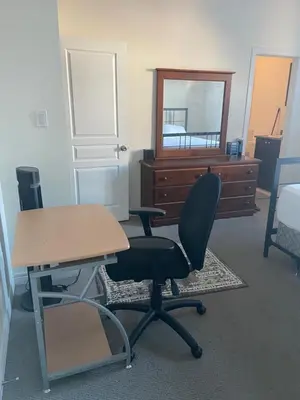 a room with a desk and a chair and a dresser at Divinity Hut in Brampton