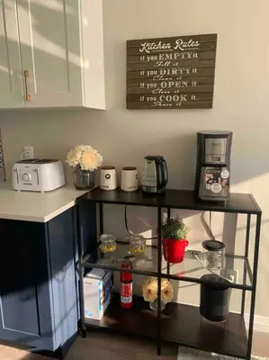 a kitchen counter with a shelf with food on it at BRAND-NEW LUXURY SUITE in DOON SOUTH, min to 401 in Kitchener