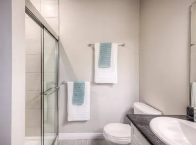 a bathroom with a shower and a toilet and a sink at BRAND-NEW LUXURY SUITE in DOON SOUTH, min to 401 in Kitchener